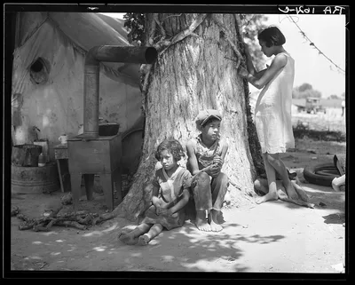 Motherless migrant children. They work in the cotton, California, 1935