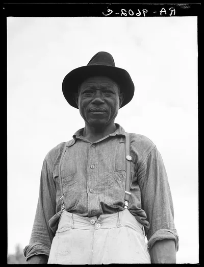At Hill House, Mississippi. He wears the union button, 1936