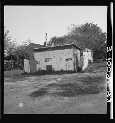 Privy in cheap migratory camp. San Joaquin Valley, California, 1936