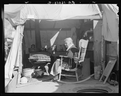 Aged woman from Oklahoma. Kern County migrant camp, California, 1936