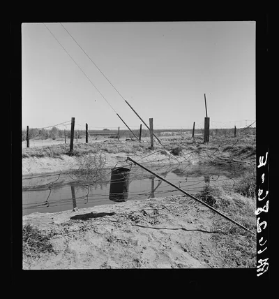 Water supply: an open settling basin from the irrigation ditch in a…, California, 1937