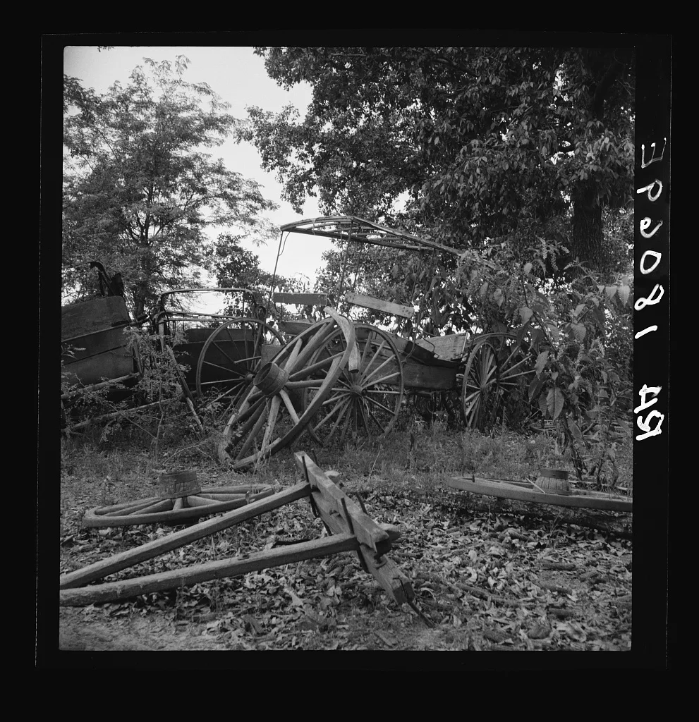 Abandoned coaches and wagons behind the old blacksmith shop on the…, Georgia, 1937
