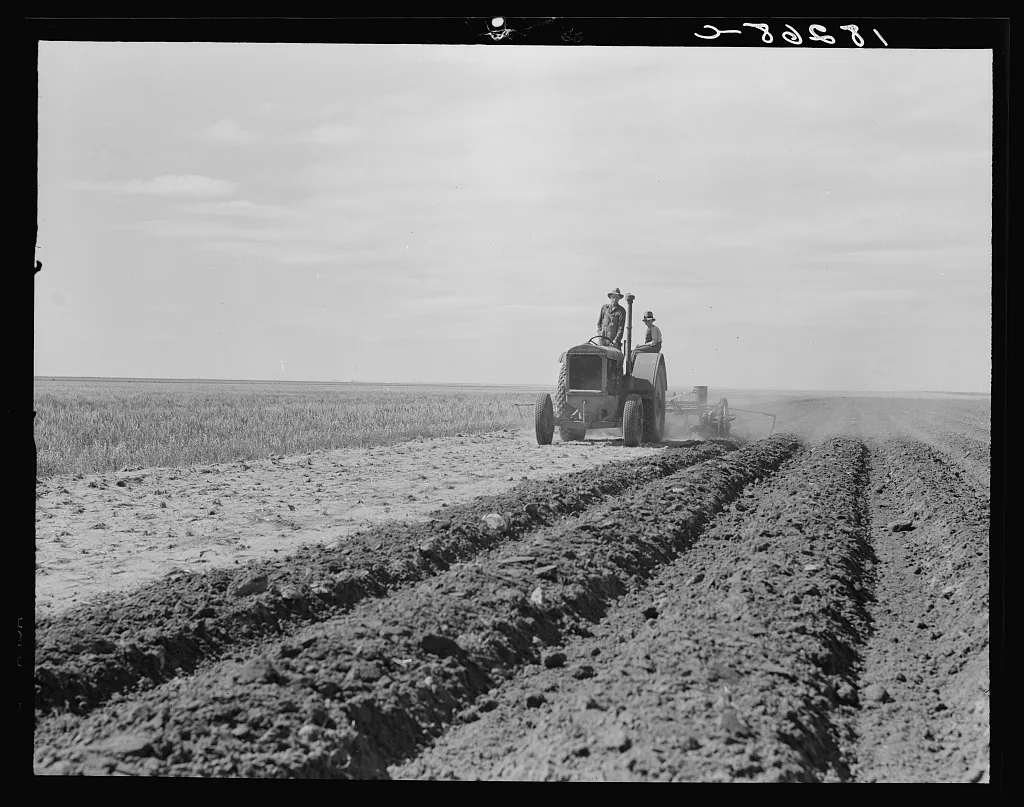 Dust bowl farmer driving tractor with young son near Cland [i.e.…, New Mexico, 1938