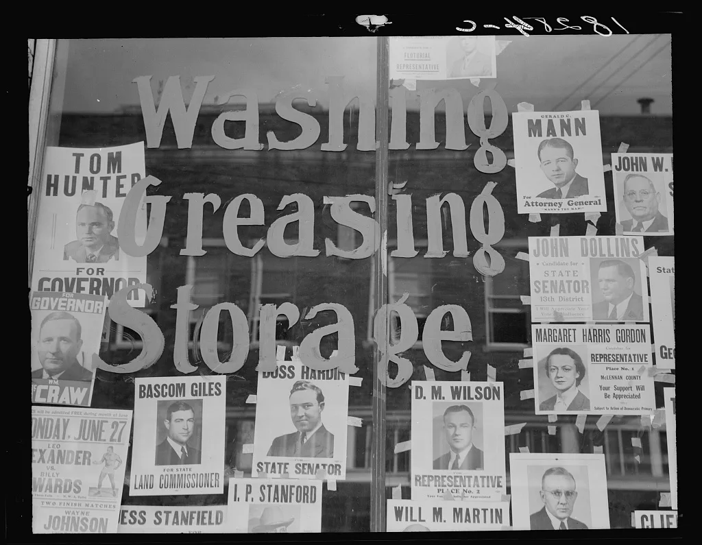 Campaign posters in garage window, just before the primary. Waco,…, Texas, 1938