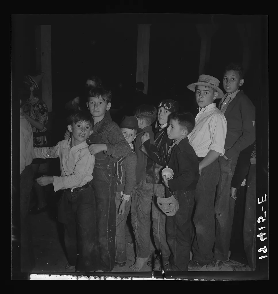 The children crowd and push to reach refreshments at Halloween party.…, California, 1938