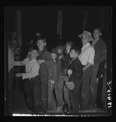 The children crowd and push to reach refreshments at Halloween party.…, California, 1938
