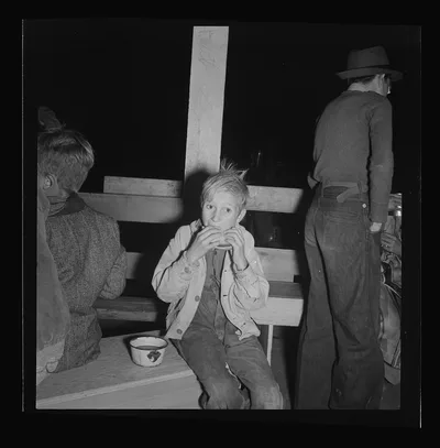 Hungry boy at the Halloween party for migrant workers. Shafter…, California, 1938