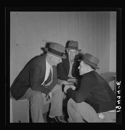 Camp manager, migratory worker, and visitor to the camp in…, California, 1938