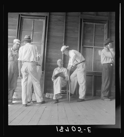 Douglas, Georgia. Farmers at tobacco auction. Common question is…, 1938