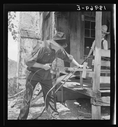In Arkansas Hills (Ozarks) near Seligman, Missouri, splitting hickory…, 1938