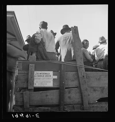 Labor contractor's truck with gang of pea pickers pulled up for gas.…, California, 1939